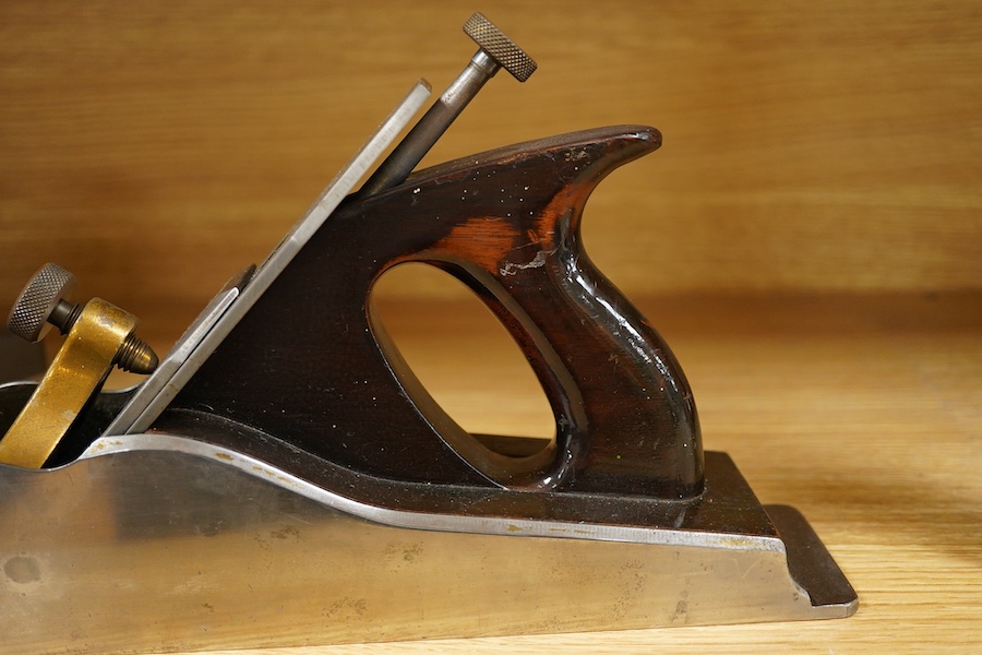 A Norris A1 adjustable steel 14 1/2” panel plane, stamped with Norris, London to both the brass lever cap and the iron, with rosewood infill